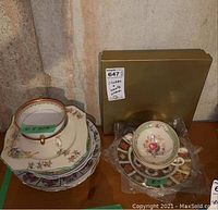 Overview: C.A. Hrenfeldt bowl on plate, Myott handled bowl and saucer, boxed Royal Crown Derby Old Imari plates