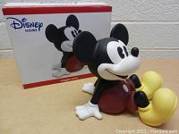 Front-side view of the Disney Mickey Mouse ceramic coin bank with original box in background