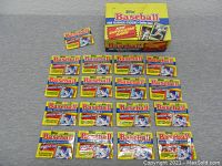 Seventeen unopened packs of 1988 Topps Baseball Yearbook sticker cards arranged on a flat surface with one box partially visible in background.