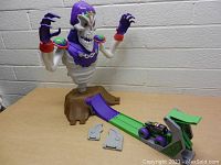 Full view of the skeleton monster figure, ramp, small parts, and Grave Digger truck