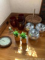 Full lot displayed including Seiko wall clock, amber glass vases, clear floral glass bowls, decorative pineapples, hand-painted bell, and wicker basket.