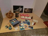 Overview of the lot showing all items included such as beer stein, perfume sets, ET cards, Star Wars items, and photographs