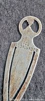 Close-up top view of silver money clip marked '.900 El Salvador'