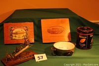 Group photo showing two wooden cigar boxes, a vintage metal scale, ceramic baby dish with bunny design, and Granger tobacco can