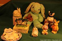 Full display of assorted Easter decor items including ceramic figures, plush bunnies, and egg holder plate