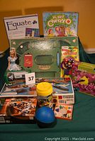 Lot overall showing boxed board games, Lego sets, doll, puzzles, toy kit, Hess truck, nerf ball