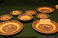 Full view of all pieces in the dishware set, including plates, cup, bowl, and saucers.