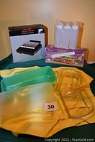 Full view of all items including boxed Alton sandwich toaster, Vidalia Chop Wizard in box, Tupperware vegetable keeper with lid, and white condiment containers.