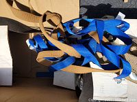 Box with various blue and tan tow straps inside