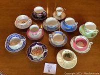Overhead view of 12 assorted tea cups and saucers