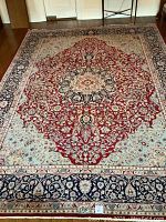 Full top-down view of rug laid on hardwood floor showing overall pattern.