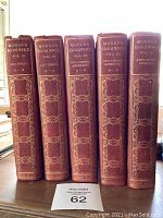 Front view of five volumes of Modern Eloquence, volumes IV to VIII with red cloth spine and gold embossing.