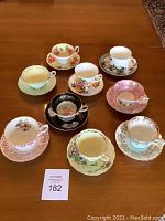 Overview of nine assorted cups and saucers arranged in grid