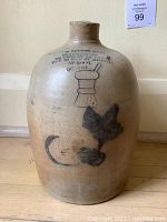 Front view showing overall form, handle, and decorative motifs