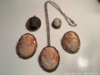 Five cameo pieces arranged on white background