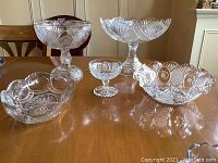 Full lot view showing three pedestal compotes and two footless bowls