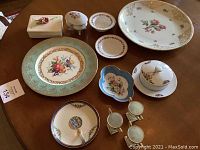 Overview of floral china items on table showing variety and arrangement