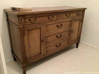 Front view showing overall buffet server with drawers and cabinet doors