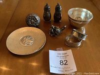 Overview of eight sterling silver pieces displayed on table