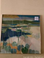 Full view of framed abstract painting hanging on wall