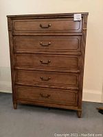 Full front view of the walnut 5 drawer highboy dresser showing brass handles and decorative fluted columns on the sides.