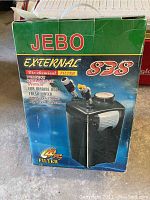 Front view of JEBO 838 aquarium filter box showing product image and key features including bio-chemical filtration for marine and freshwater use with strong restoration capacity.