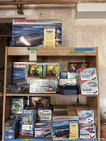 Full view of shelf with aquarium supplies including Marineland filter boxes, decorative items, and smaller equipment