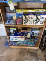 Shelf with boxed Tetra Whisper Power Filters, Marineland Power Filter box, Via Aqua air pump box, and various Bio Bag filter media packages and aquarium accessories.
