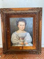 Front view of the original oil painting showing the entire framed portrait of the child.