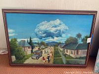 Frontal view of the framed painting showing the detailed rural scene with houses, people, and cloud formation.