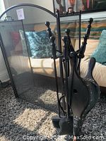 Full view of the fireplace tool set with stand and large fire screen behind it, showing all items together indoors.