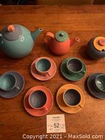 Full set front view showing all pieces arranged on table with label.