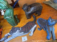 Four cat art pieces displayed on wooden floor for size and condition overview