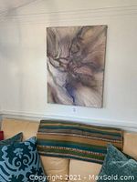 Full view of original acrylic on canvas painting titled "Interaction" by Geoffrey Armstrong, mounted on wall above couch.