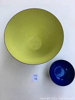 Top view of the large green Krenit Denmark bowl and smaller blue Emalox Norway bowl showing size comparison and vivid colors.