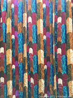 Close-up view of the barkcloth fabric pattern showing colorful geometric arches in blue, orange, red, purple, white, and green with textured appearance.