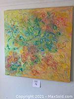 Closer angled view of square colorful acrylic painting showing detail and texture.