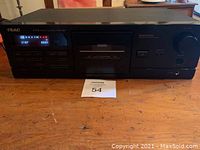 Front view of TEAC R-560 cassette deck powered on showing digital display and controls