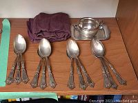 All items laid out: 12 spoons, sugar bowl and tray