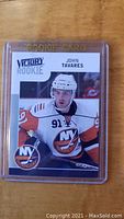 Front of 2009-10 Upper Deck Victory John Tavares rookie card with player image and Victory Rookie branding