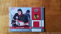 Front side of the 09-10 Upper Deck Patrick Kane Game Jersey card showing the embedded red jersey swatch and photo of Patrick Kane in Chicago Blackhawks uniform.