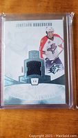 Front of Jonathan Huberdeau rookie materials card showing player image and embedded jersey patch numbered 11