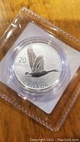 Front of the 2014 Canadian $20 silver coin showing flying Canada Goose and inscriptions.