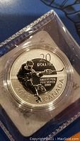 Close-up of the silver coin showing a hockey player, denomination $20, year 2013, Canada, and fine silver purity 9999 stamped on coin.