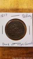Obverse side of the 1857 Bank of Upper Canada half penny showing mounted figure design and date.