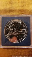 Reverse side of the coin showing steam locomotive and text 'CANADA DOLLAR 1886 VANCOUVER 1986'.