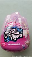 Front view of unopened packaging showing the Hatchimals Pixies Crystal Flyers logo, with sparkle effect and pink crystal egg shape