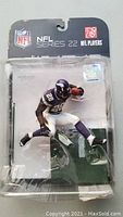 Front view of unopened McFarlane NFL Series 22 Adrian Peterson football figure in packaging.