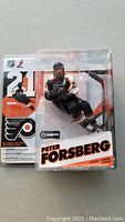 Front and back view of unopened Peter Forsberg McFarlane hockey figure in original packaging showing figure with stick, Flyers branding, and Series 12 label.