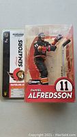 Photo of unopened McFarlane hockey figure featuring Daniel Alfredsson in Ottawa Senators uniform Series 9, showing front package condition and figure inside.